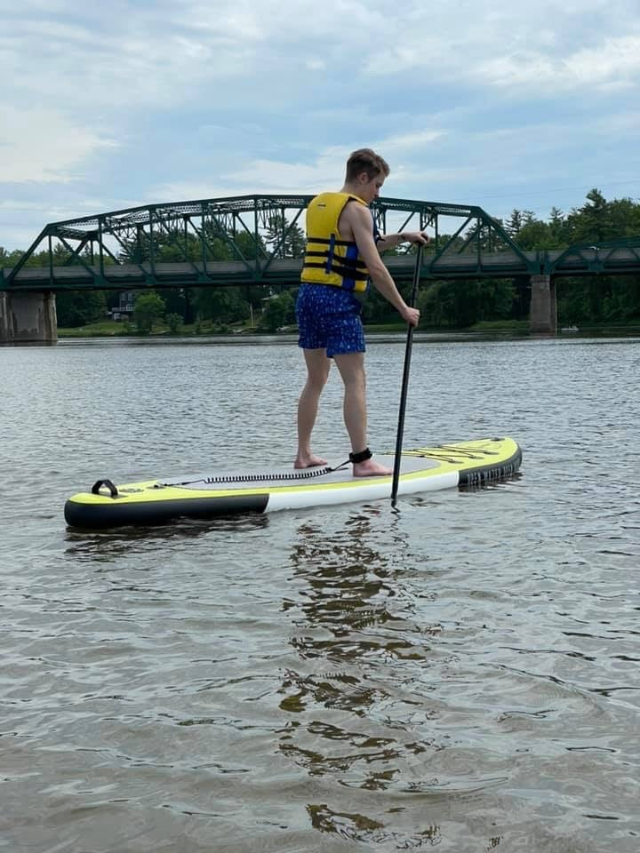customer using the Chaudière Inflatable Paddleboard out on the river
