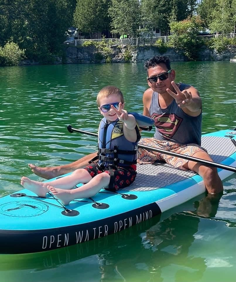 A man and his son spending qualoty time together out on the water using one of our quality standup paddleboards